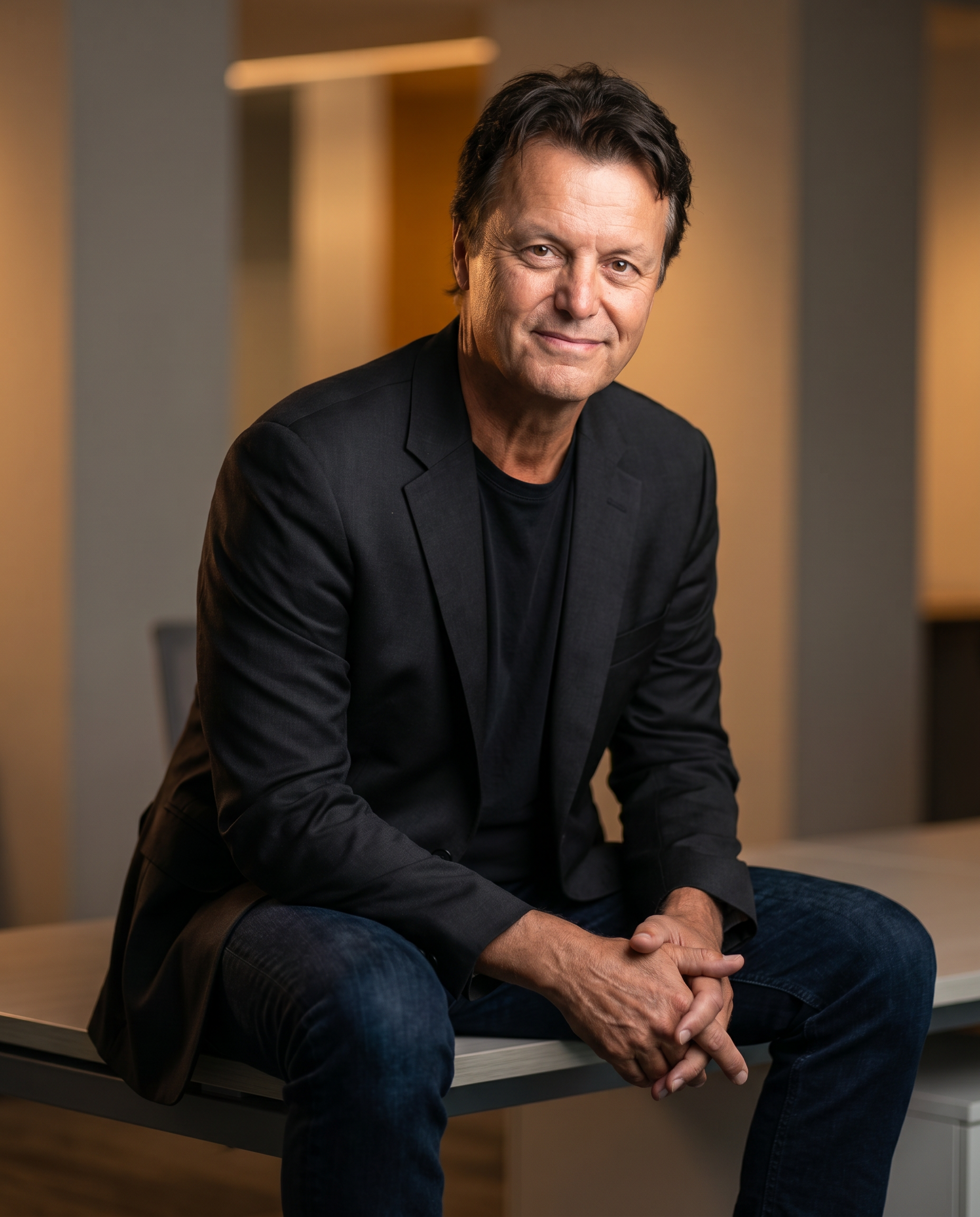 Nick VandenBrekel seated in a modern office, photographed in editorial style